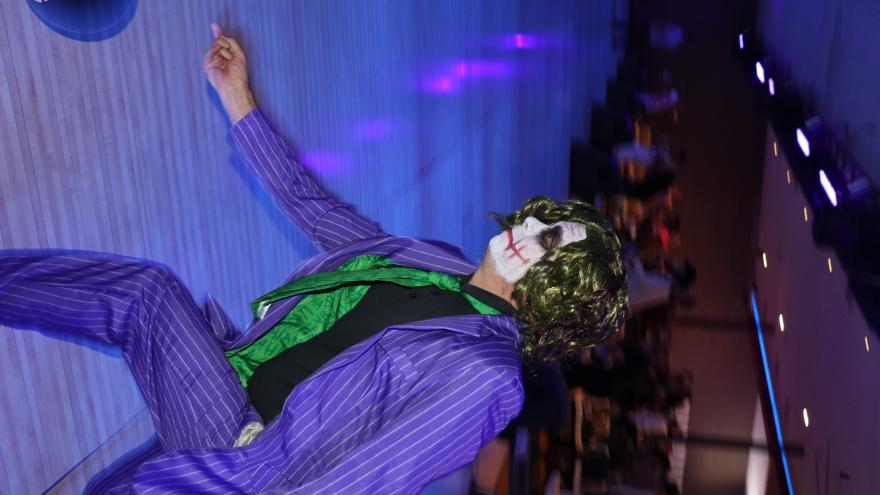 Bowler in a Joker costume bowling