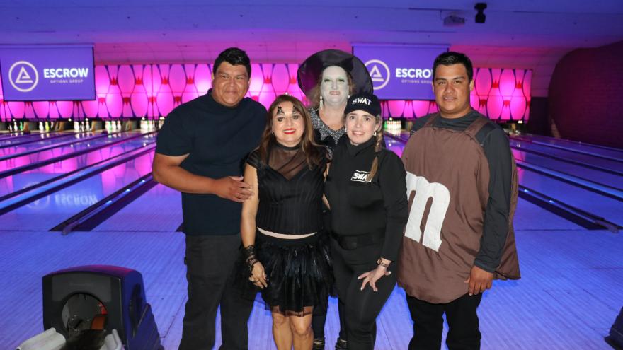 Group of bowlers in costume posing for a picture